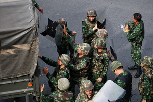 Thai soldiers disembark from a truck after being deployed at a business intersection in Bangkok, Thailand. Photo / AP