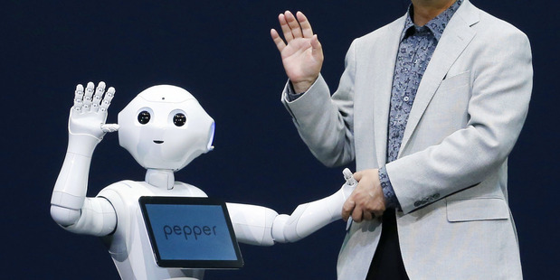 Softbank Corp. President Masayoshi Son, right, and Pepper, a newly developed robot. Photo / AP