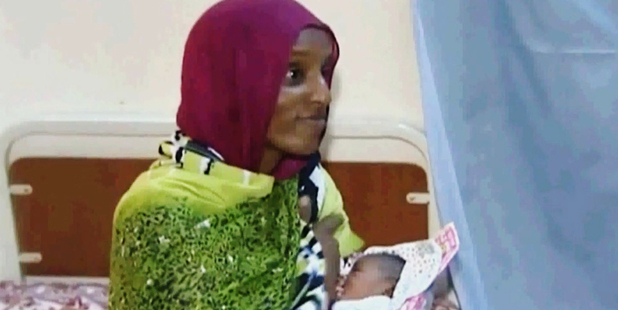 Meriam Ibrahim breastfeeds her newborn baby girl. Image / Al Fajer/AP