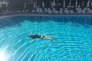 Lorde floating in the pool of her hotel in Rome this week.