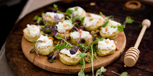 Blini with goat's cheese, honey and micro greens. Photo / Babiche Martens.