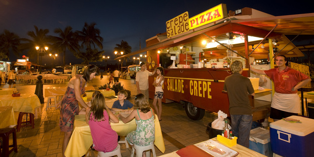 Tourists dine at a roadside eatery in Tahiti.