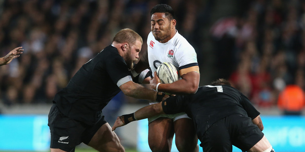 Owen Franks is making sure England's Manu Tuilagi can't get away. Photo / Getty Images