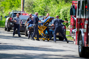 Rescue workers take the stabbing victim to the ambulance in Waukesha, Wis. Photo / AP