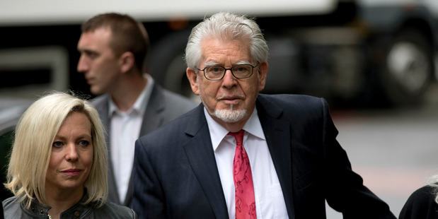 Rolf Harris, centre, arrives for his trial with his daughter Bindi. Photo / AP
