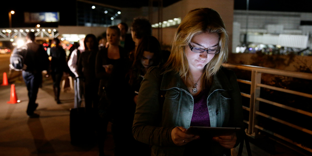 Consumers have embraced digital news and entertainment, and no longer distinguish between new and old media, says a new report. Photo / AP