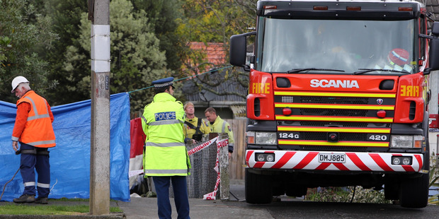 Police and fire officers at the scene on Second Ave, after the body of a man was discovered in the Wairohia Stream this morning. PHOTO: JOHN STONE