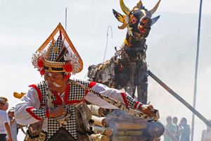 A Balinese dancer performs during a cremation ceremony at a beach in Bali. Photo / AP