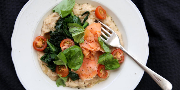 Garlicky butter bean mash topped with smoked salmon and braised greens. Photo / Eleanor Ozich