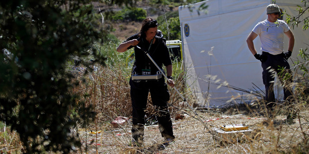 A British policewoman uses ground-penetrating radar inside a cordoned-off area in Praia da Luz. Photo / AP