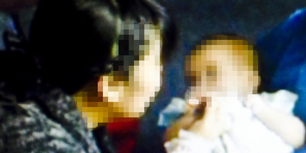 The mother holds her baby but cannot be left alone with her. Picture / TV3