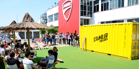 Ducati line up to view the prototype Ducati Scrambler hidden in a yellow container at the Ducati factory in Bologna. Photo / Supplied