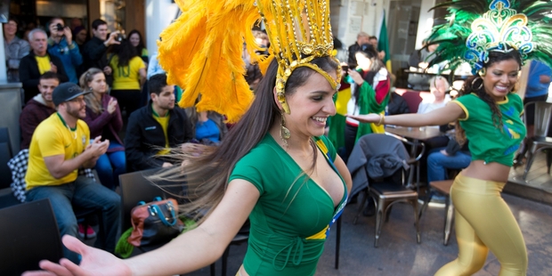 Dancers and fans Gabriela Guimaraes and Aline Silva entertain a big crowd at Ponsonby's Santos Cafe watching their home side play Croatia yesterday. Photo / Greg Bowker