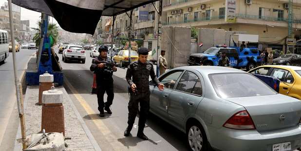 Iraqi federal policemen stand guard at a checkpoint in Baghdad, Iraq. Photo / AP