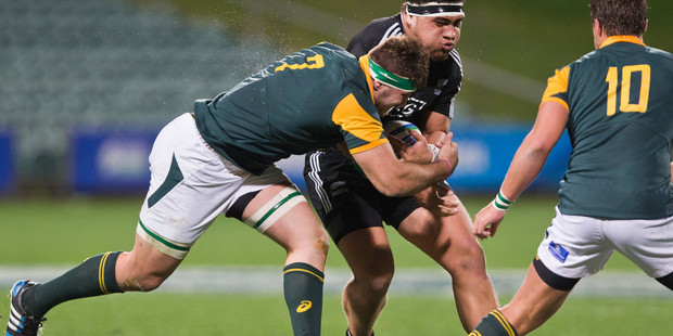 South Africa's Cyle Brink tries to bring down New Zealand's Atunaisa Moli during the IRB Junior World Championship. Photo / Greg Bowker