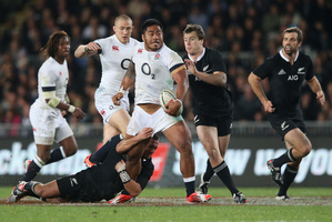 Manu Tuilagi of England is tackled by Aaron Cruden during the International Test Match between the New Zealand All Blacks and England at Eden Park. Photo / Greg Bowker.