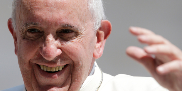 Pope Francis smiles as he waves to faithful at the end of his weekly general audience in St. Peter's Square at the Vatican. Photo / AP