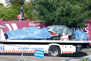 The remains of the Audi R18 E-Tron No1 driven by Loic Duval are brought back to the pits after it crashed during a free practice session for the 24-hour Le Mans endurance race. Photo / AP
