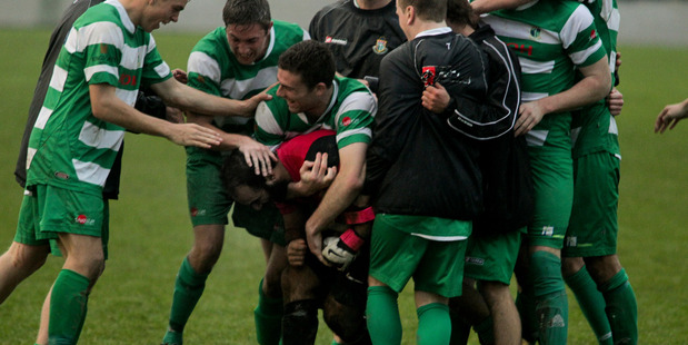 Palmerston North Marist mob their hero goalkeeper Gurkarnur Singh after beating Napier City Rovers in a penalty shootout last year.