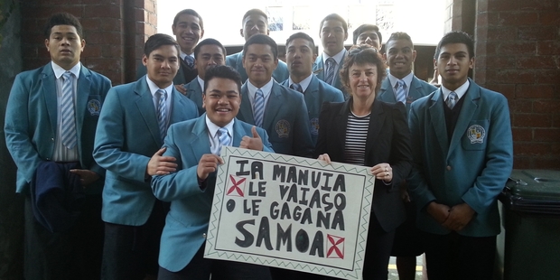 Students at St Patrick's College, Silverstream, re-enact a photo of the school's first Samoan boarders with  Dame Susan Devoy.