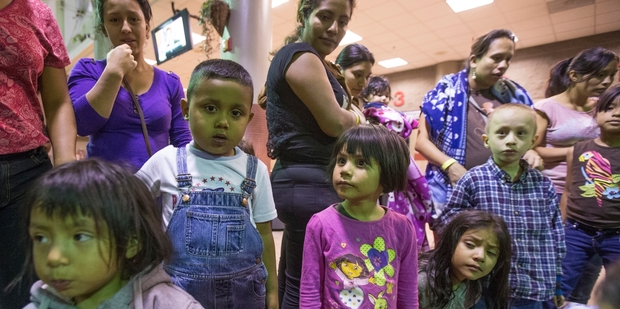 Migrants are released from custody at a bus station in Phoenix, Arizona. Photo / AP