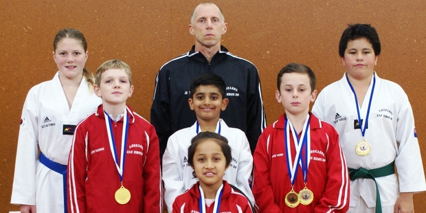 Aotearoa Taekwondo's team, back row: Faith Waterman (left), Jim Thomas (assistant coach), Tristan Hanlen. Middle row: Orion Thomas, Lakshya Dhillion, Blake Ward. Front: Mahinarangi Wirihana.