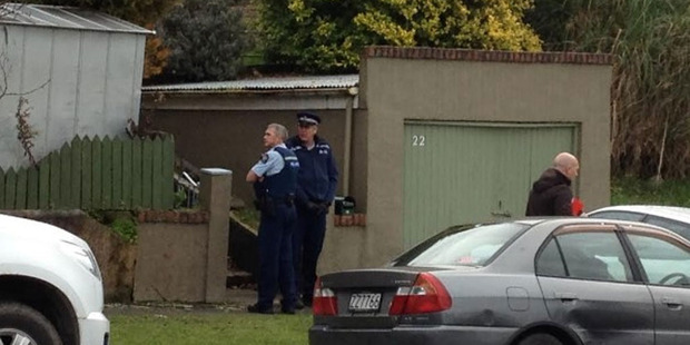 The disabled boy was led away from the house clad only in his pajamas and socks after the body of a woman was found in the house where he lived. Photo / Craig Baxter