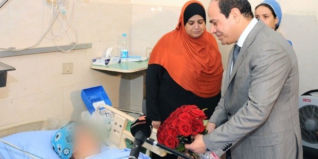 A handout picture released by the Egyptian presidency shows newly elected president Abdel Fattah al-Sisi visiting the victim of a sexual assault. Photo / AFP