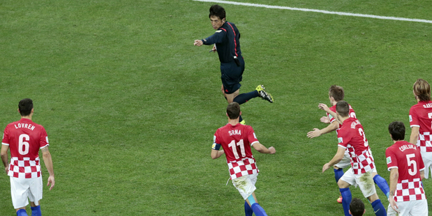 Referee Yuichi Nishimura from Japan points to the spot following a 'foul' on Fred. Photo / AP