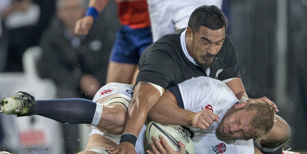 Jerome Kaino tackles England captain Chris Robshaw. Photo / Brett Phibbs