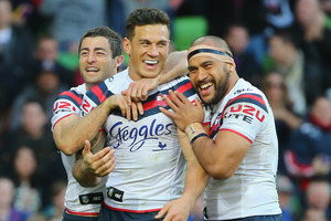 Sonny Bill Williams of the Roosters is congratulated by his teammates after scoring against the Storm. Photo / Getty Images