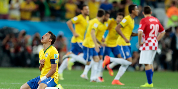 Brazil's Thiago Silva, left, celebrates after teammate Neymar scored to make it 1-1. Photo / AP