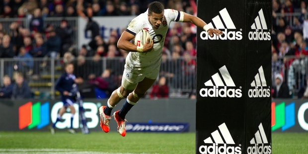 England winger Anthony Watson soars over the touchline. Photo / Brett Phibbs