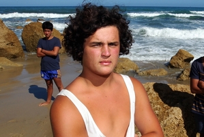 St John's College student Lucan Battison was suspended for refusing to cut his hair and has his parents' support.