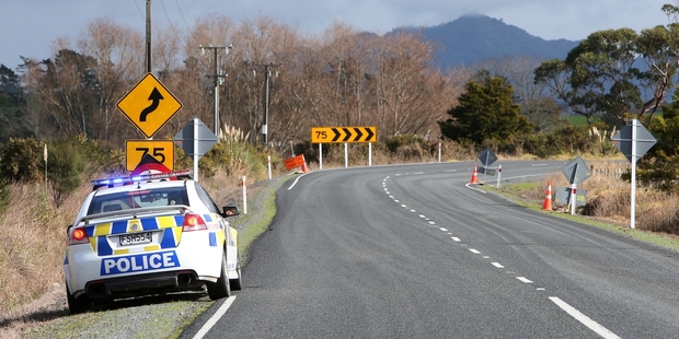 A police officer waiting on Mangakahia Rd just north of the Whatatiri Rd/Kokopu Rd intersection had road spikes ready to stop the vehicle officers were hunting. Photo / Michael Cunningham