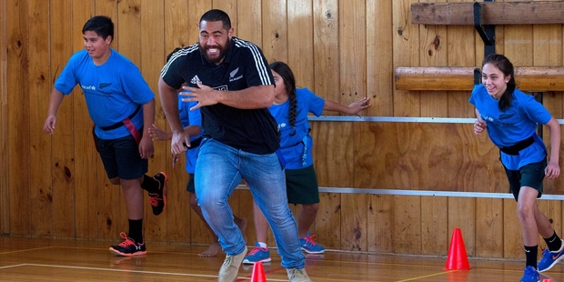 Charlie Faumuina takes part in a game at Melville Intermediate School, Hamilton, yesterday during a promotional visit with other All Blacks. Photo / Alan Gibson