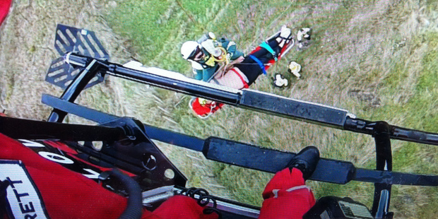 Paramedic Ryan Sutherland assists with winching a man into the Lowe Corporation Rescue Helicopter after a fall in Tangoio, north of Napier, yesterday. Photo/Supplied
