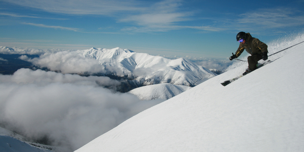 A skier carves up the powder at the top of Porters Ski Field in Canterbury.