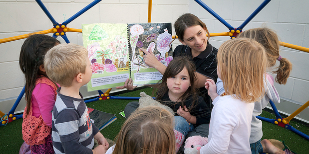 Pukeko Room team leader Sara Wilson reads to some of the preschoolers at Active Kids Early Childcare Centre in First Ave on Friday. PHOTO/ANDREW WARNER