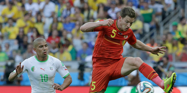 Algeria's Sofiane Feghouli, left, chases after Belgium's Jan Vertonghen during the group H World Cup soccer match between Belgium and Algeria. Photo / AP.