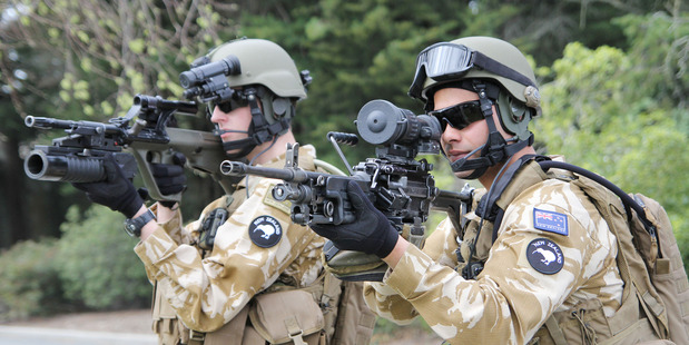 Private Chris Thomson, left, holding a Steyr Assault Rifle configured with a grenade launcher.