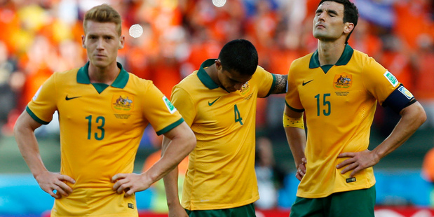 From left, Australia's Oliver Bozanic, Australia's Tim Cahill and Australia's Mile Jedinak walk off the pitch following the team's 3-2 loss to the Netherlands. Photo / AP