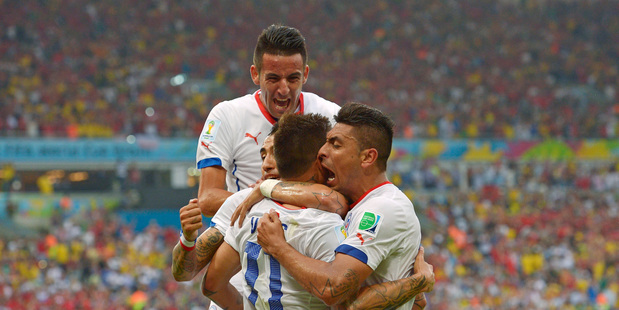 Chile's Eduardo Vargas, centre, celebrates with teammates after scoring the opening goal against Spain. Photo / AP