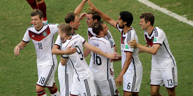 Teammates celebrate with Germany's Thomas Mueller, right, after his scored his third goal and the team's fourth against Portugal. Photo / AP