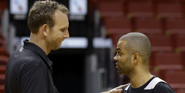 Spurs assistant coach Sean Marks, left, talks with Tony Parker. Photo / AP