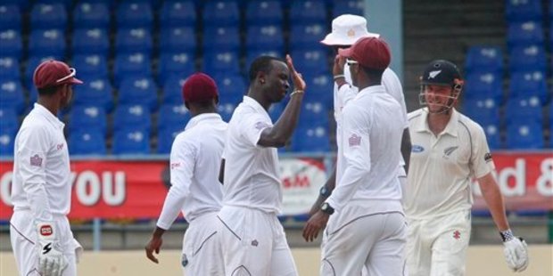 West Indies bowler Kemar Roach, center, celebrates with teammates after taking the wicket of New Zealand's Mark Craig who was caught behind by West Indies' Denesh Ramdin for 67. Photo / AP