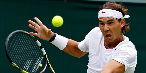 Rafael Nadal says the All England Club is a special place but admits he is vulnerable on grass. Photo / AP
