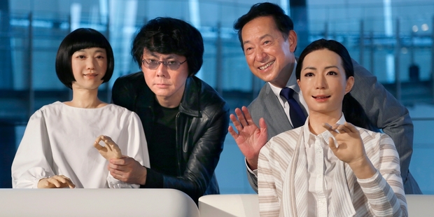 Hiroshi Ishiguro (left) and Miraikan's Mamoru Mohri pose with a robot Otonaroid (right) and Kodomoroid. Picture / AP