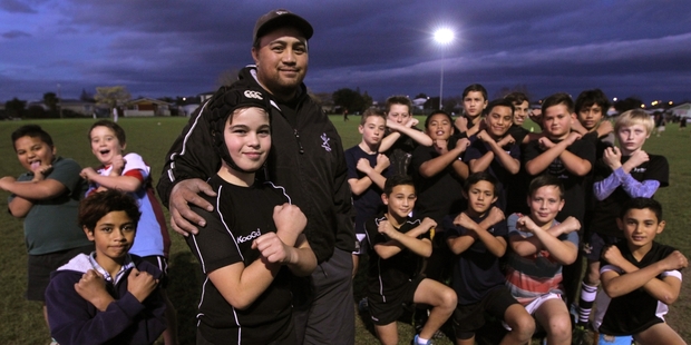 Napier Pirates Rugby Club prop William Marsden (front) with coach David Taukamo and the rest of the 11th grade team, giving their victory salute. Photo/Duncan Brown