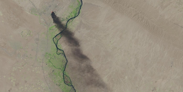 A satellite image shows smoke pouring from the Baiji refinery, where Iraqi troops and Isis rebels have been fighting.
